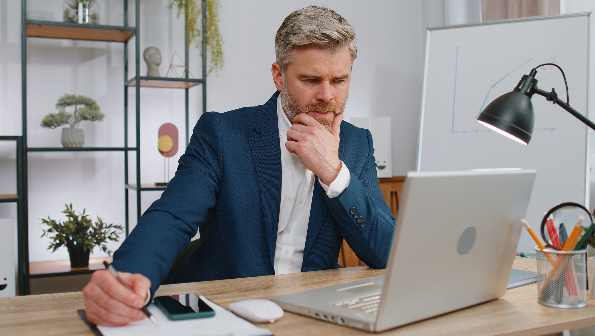 young-man-using-laptop-desk-office